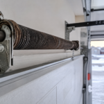 Close-up of a worn garage door torsion spring with rust, common cause of garage door spring repair in Regina